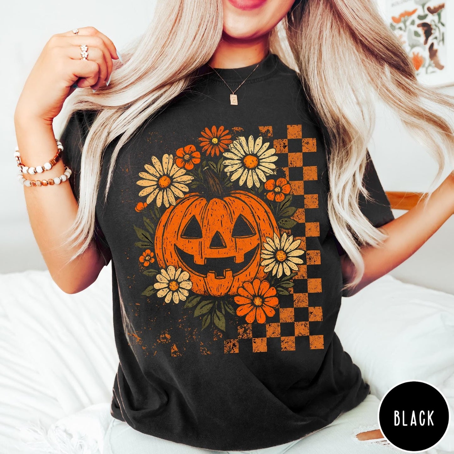 Comfort Colors tee in Black featuring retro floral jack-o'-lantern graphic with a checkered pattern side design