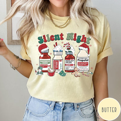 Comfort Colors tee in Butter featuring holiday medical design with vials decorated as festive holiday treats