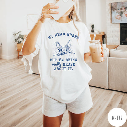 Comfort Colors tee in White featuring line art graphic of a bunny resting its head on a pillow