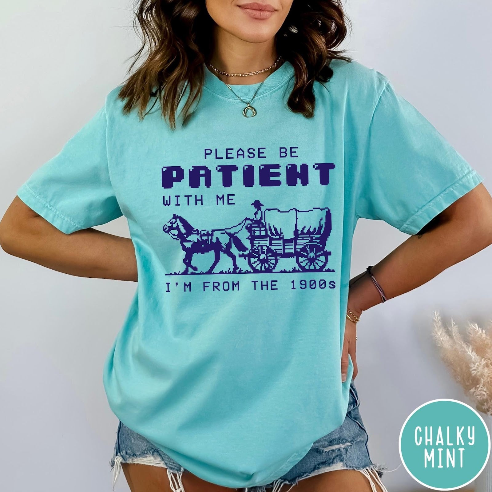 Comfort Colors tee in Chalky Mint featuring pixel art style graphic of a horse drawn covered wagon