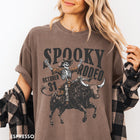 Comfort Colors tee in Espresso featuring western style graphic of a skeleton cowboy riding a bucking bull