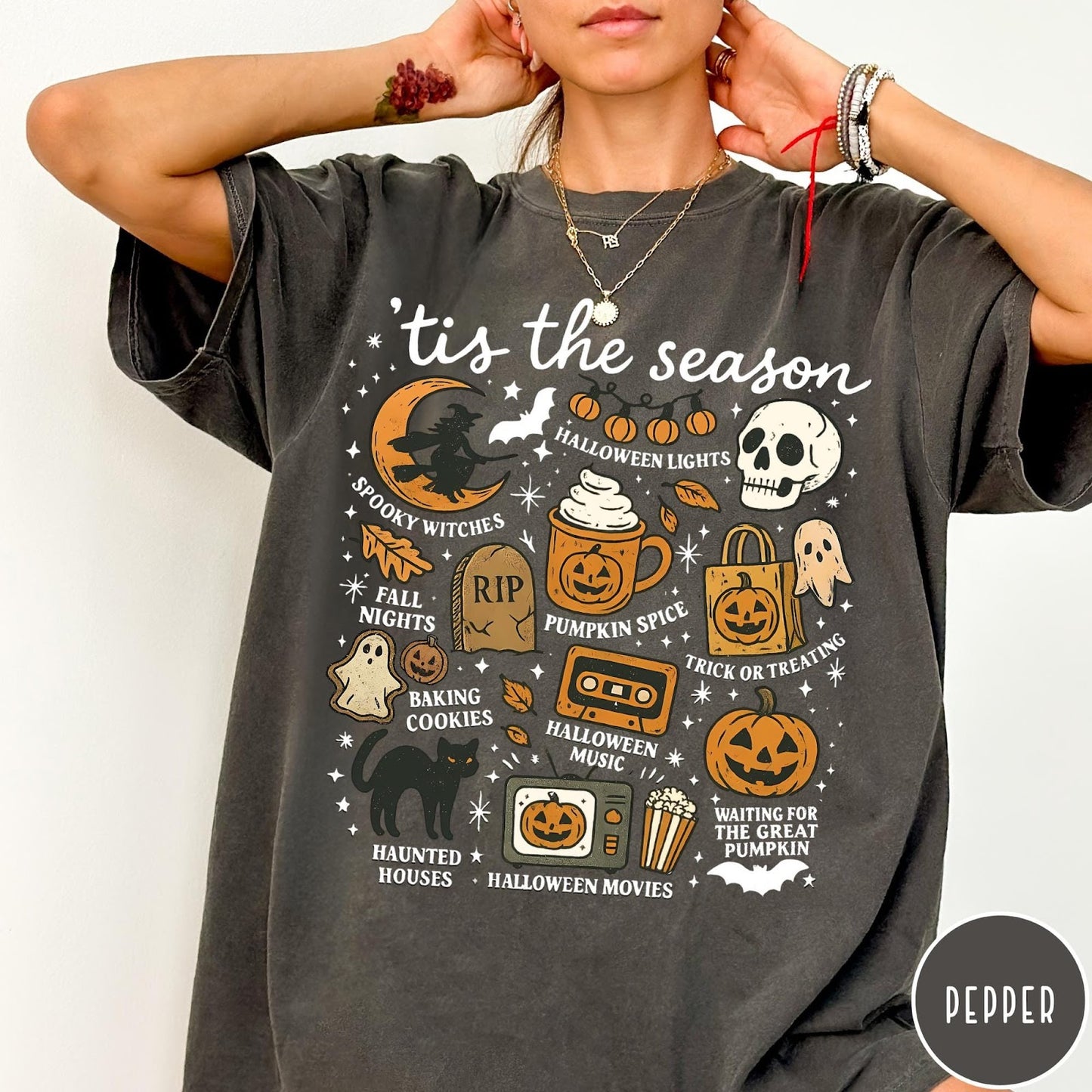 Comfort Colors tee in Pepper featuring Halloween icons collage with witch, skull, pumpkin, and spooky fall graphics