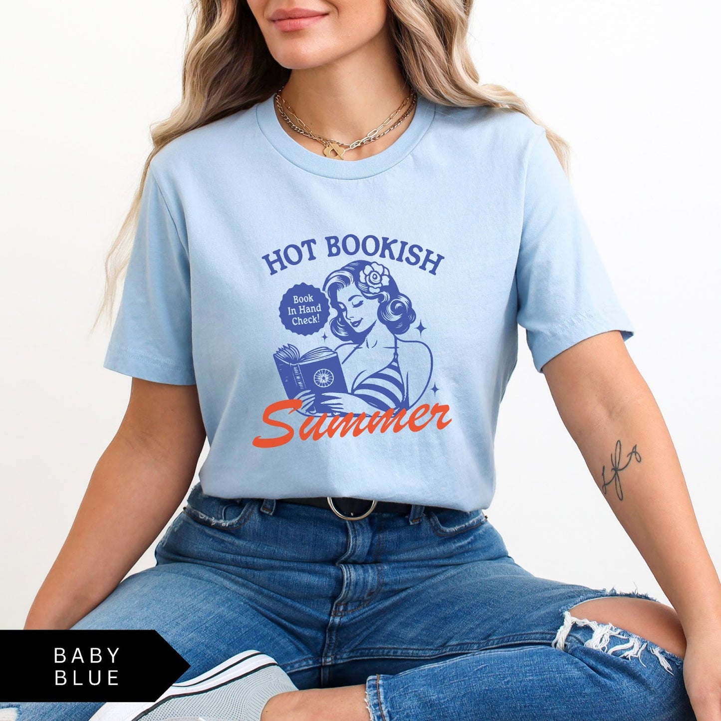Comfort Colors tee in Baby Blue featuring pinup girl reading a book graphic design with blue and orange ink