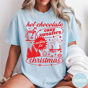 Comfort Colors tee in Chambray featuring holiday graphic design with hot chocolate, fire, and Christmas trees