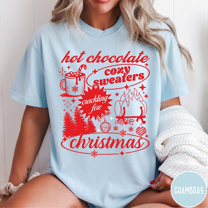 Comfort Colors tee in Chambray featuring holiday graphic design with hot chocolate, fire, and Christmas trees