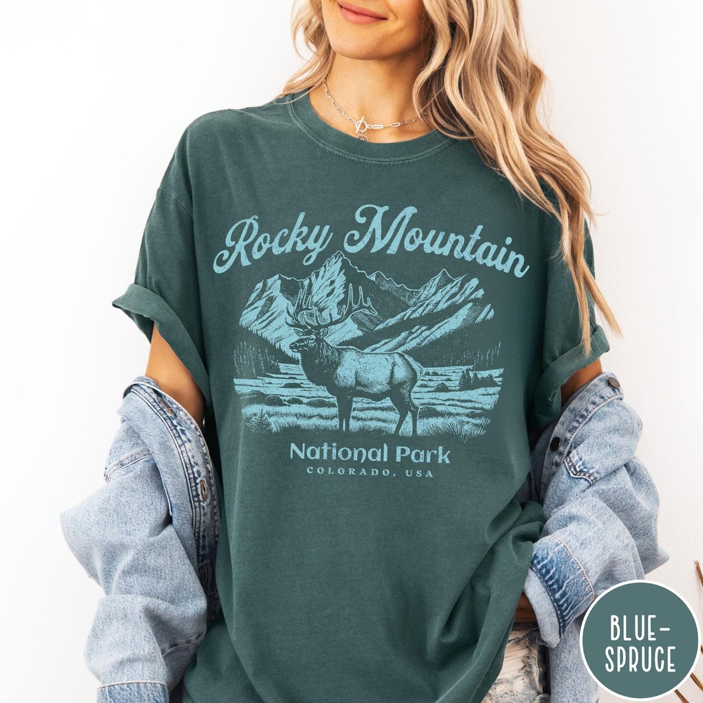 Comfort Colors tee in Blue Spruce featuring vintage style graphic of an elk standing in front of mountains