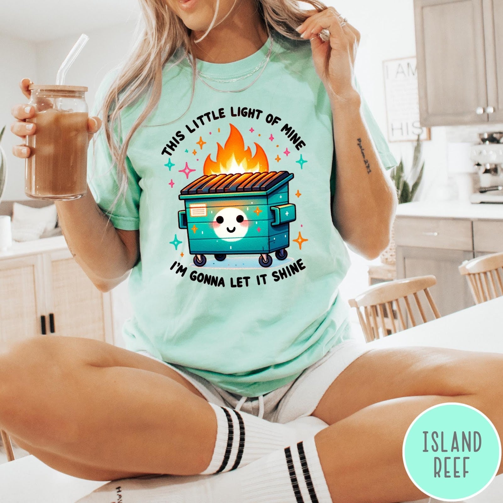 Comfort Colors tee in Island Reef featuring cartoon style graphic of a smiling dumpster fire with text