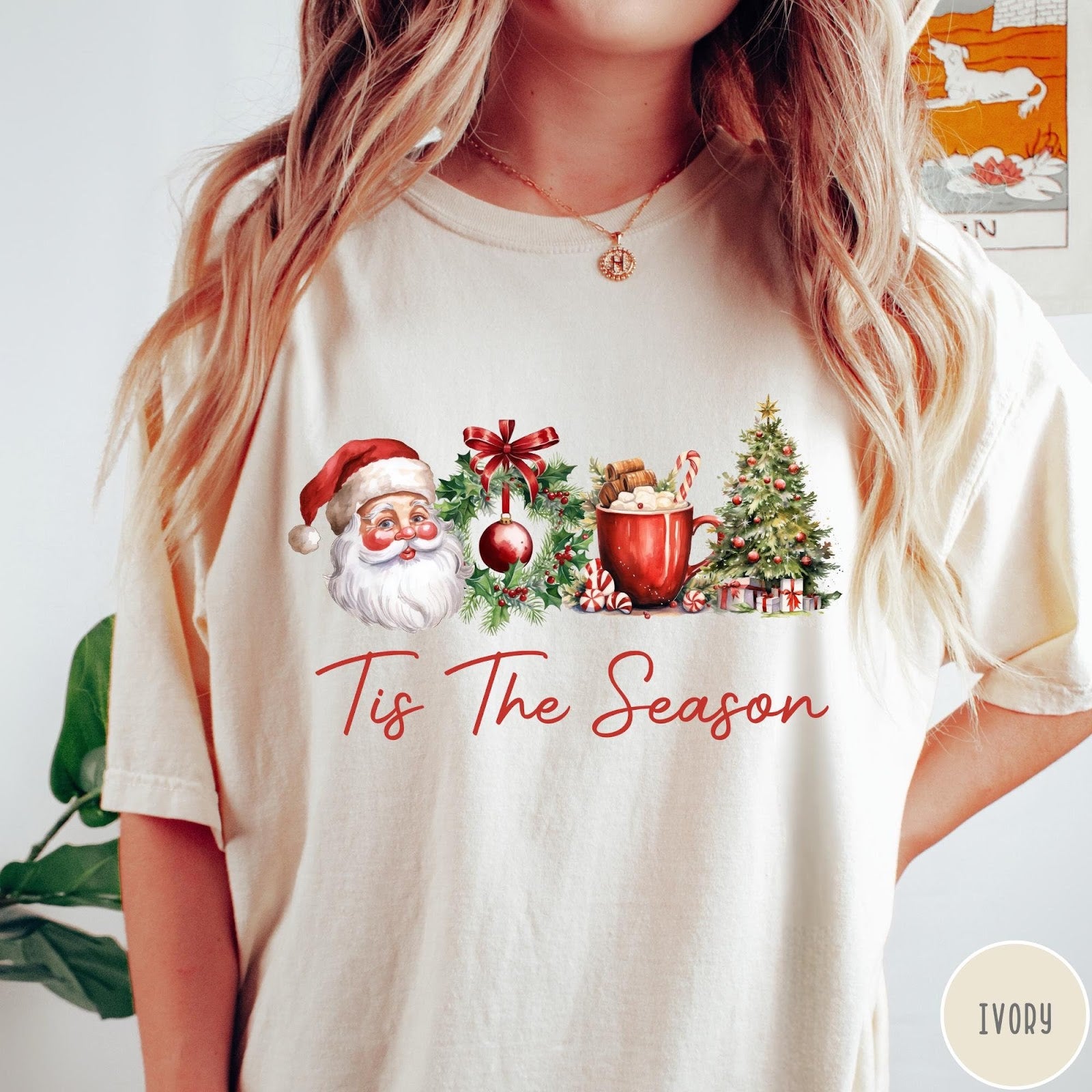 Comfort Colors tee in Ivory featuring holiday design with Santa, wreath, hot cocoa, and Christmas tree graphic