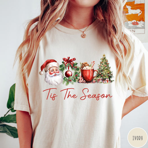 Comfort Colors tee in Ivory featuring holiday design with Santa, wreath, hot cocoa, and Christmas tree graphic