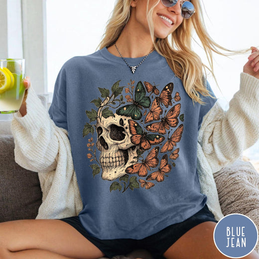 Comfort Colors tee in Blue Jean featuring vintage style graphic with a skull surrounded by various colorful butterflies