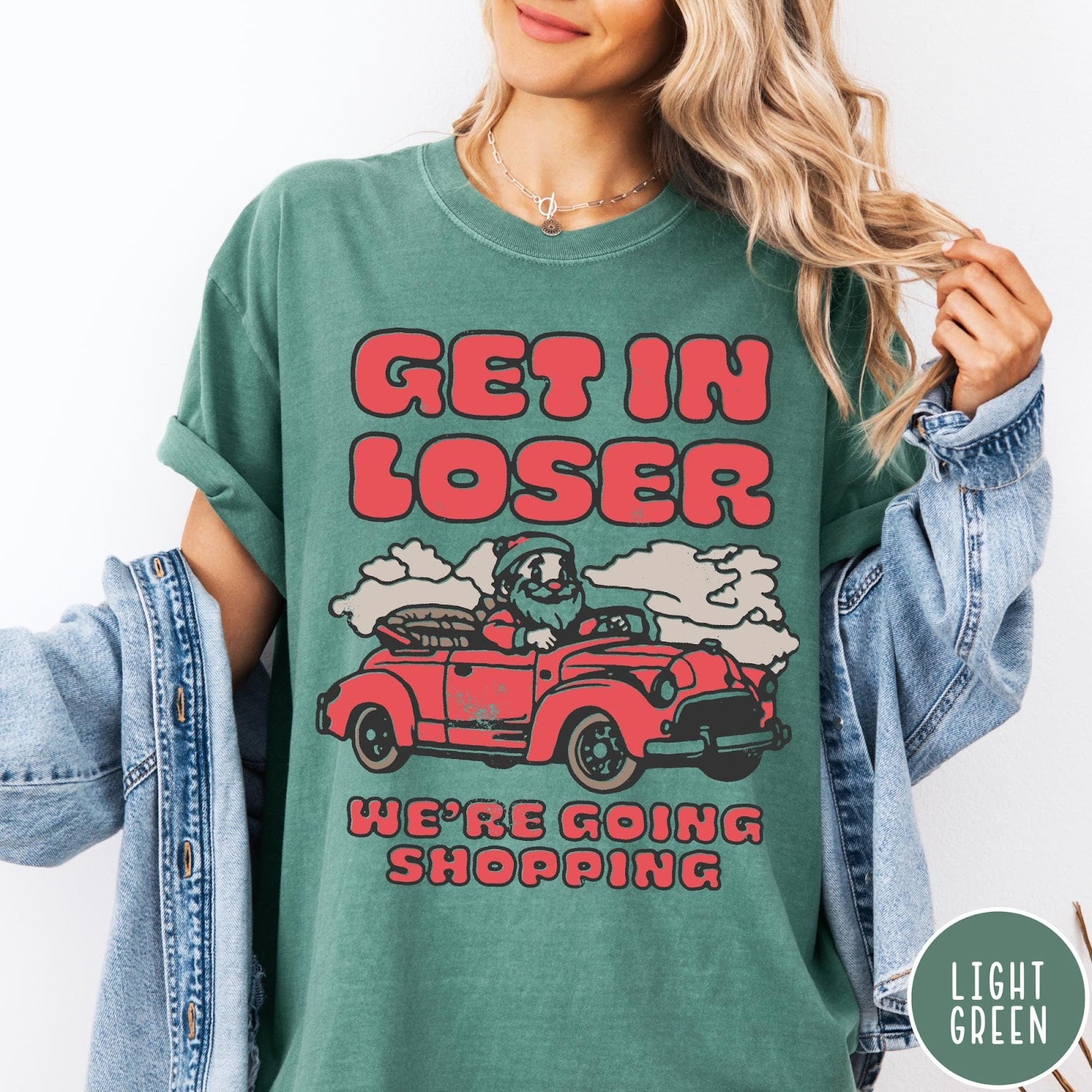 Comfort Colors tee in Light Green featuring retro style graphic of Santa Claus driving a red convertible car