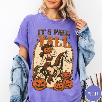 Comfort Colors tee in Violet featuring western graphic of a pumpkin cowgirl riding a skeleton horse with pumpkins