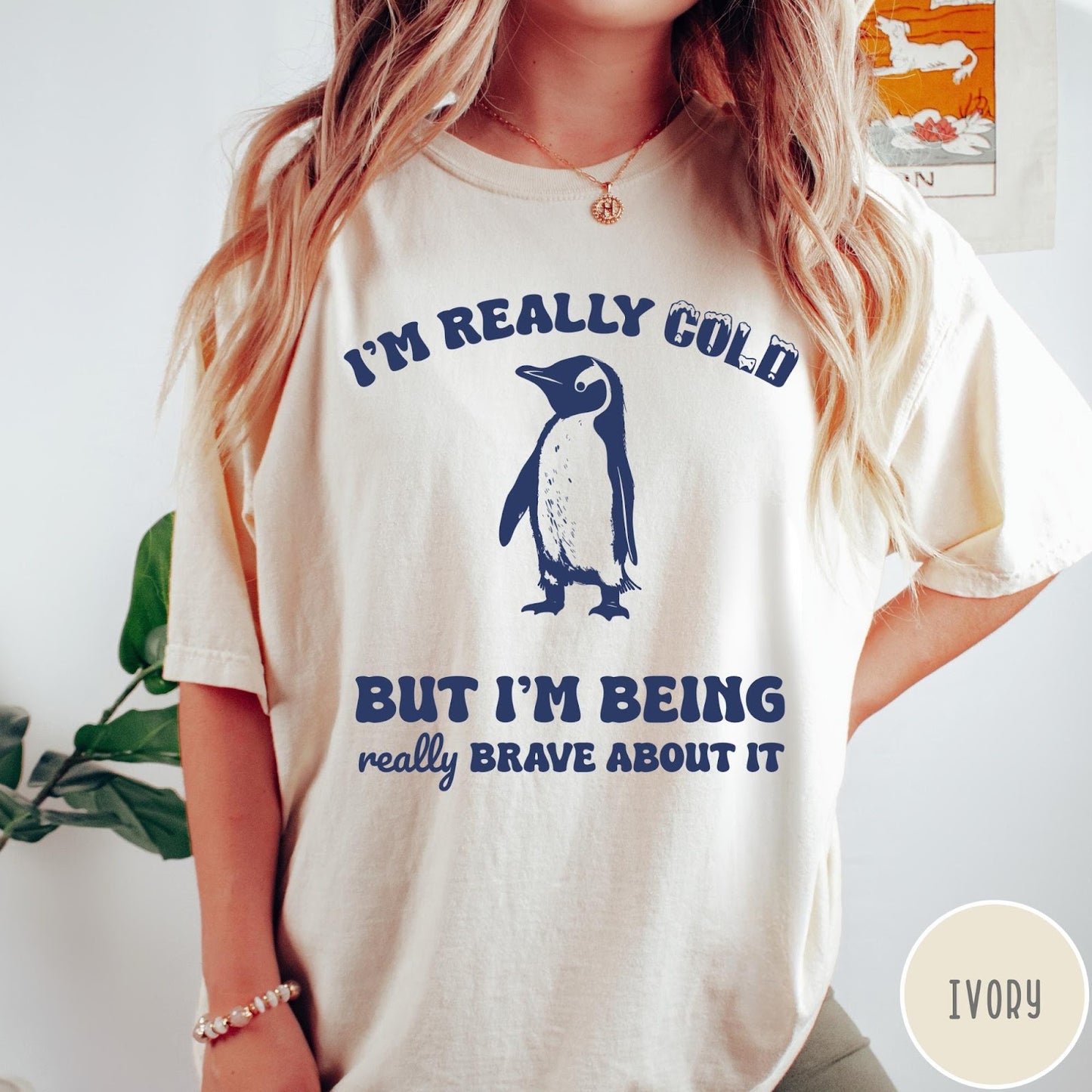 Comfort Colors tee in Ivory featuring penguin graphic with text I am really cold but I am brave