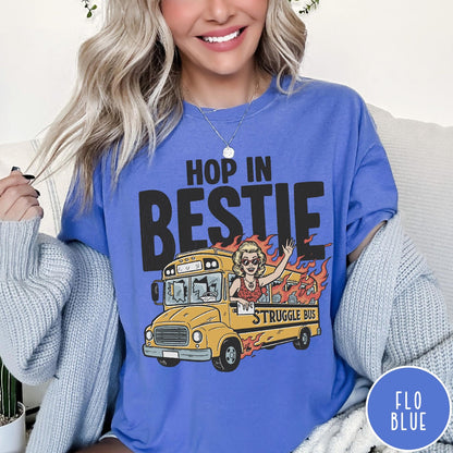 Comfort Colors tee in Flo Blue featuring retro cartoon style graphic of a woman driving a burning bus