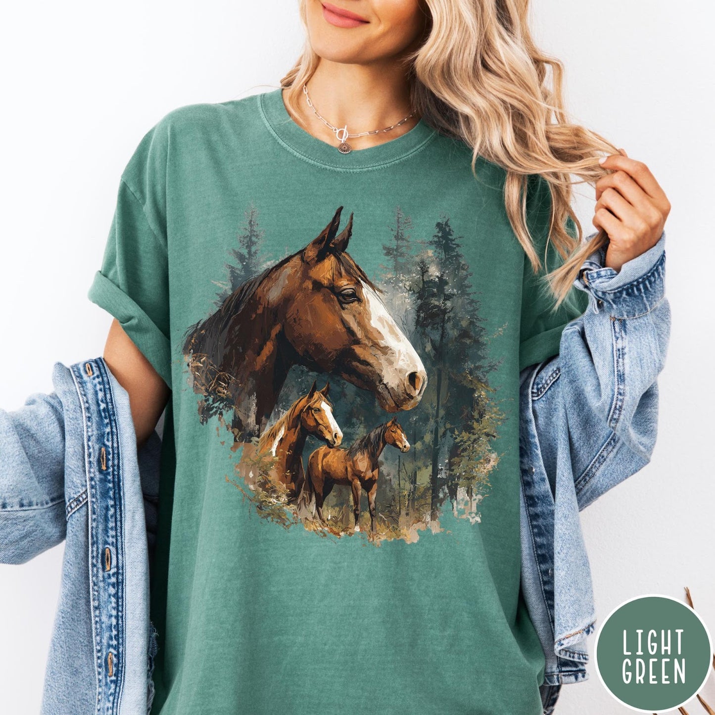 Comfort Colors tee in Light Green featuring vintage style graphic of three horses standing in a pine forest