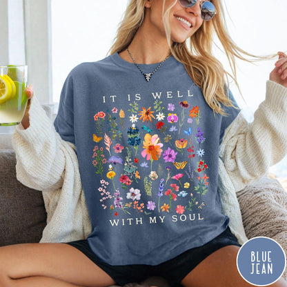 Comfort Colors tee in Blue Jean featuring wildflower bouquet graphic and It Is Well With My Soul text