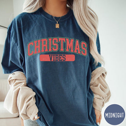 Comfort Colors tee in Midnight featuring Christmas holiday theme graphic with red and green text design