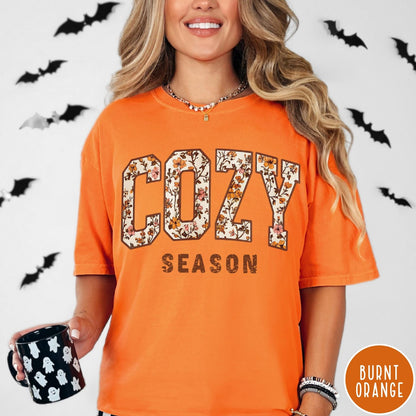 Comfort Colors tee in Burnt Orange featuring autumnal floral typography with a cozy season graphic design