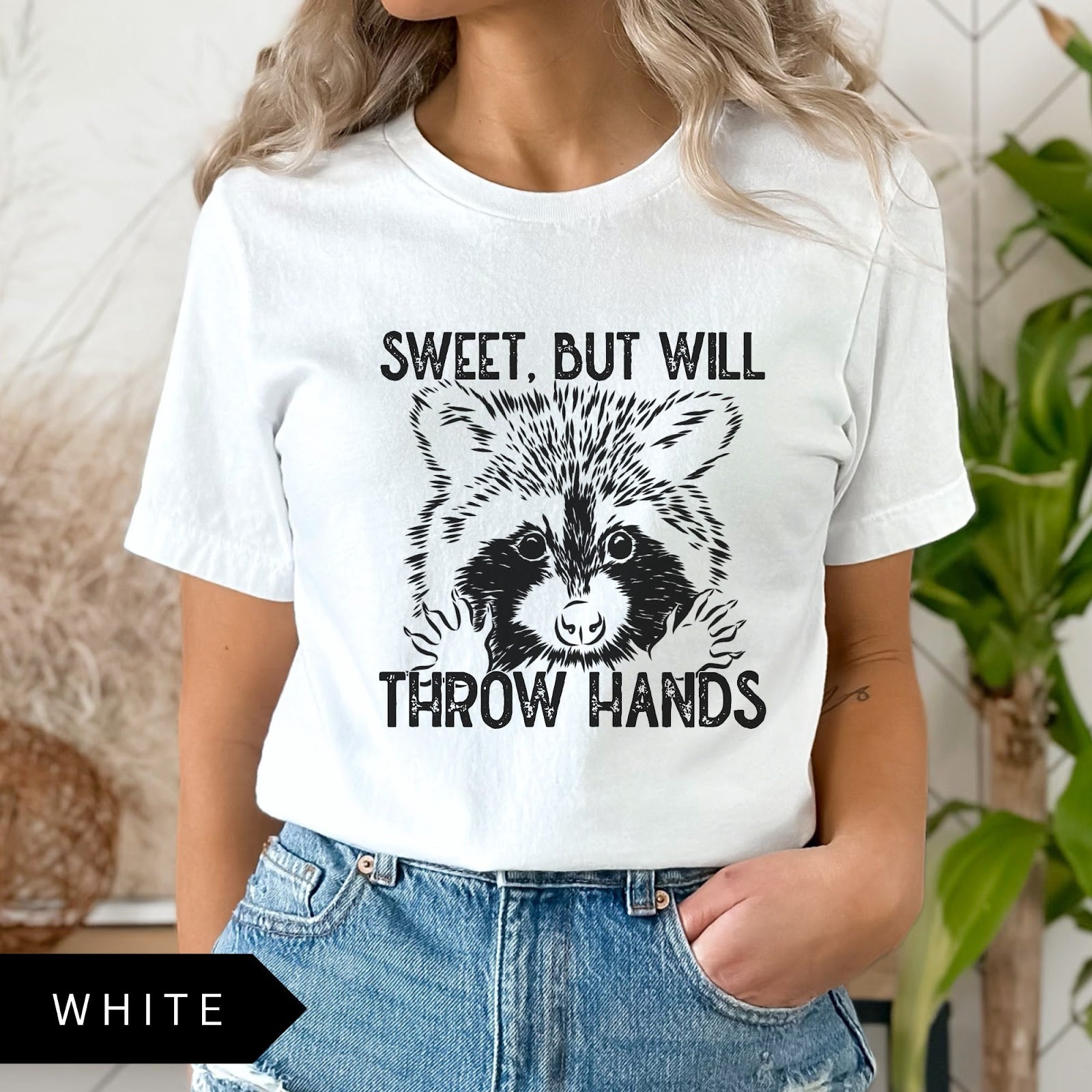 Comfort Colors tee in White featuring graphic style raccoon illustration with text Sweet, but will throw hands