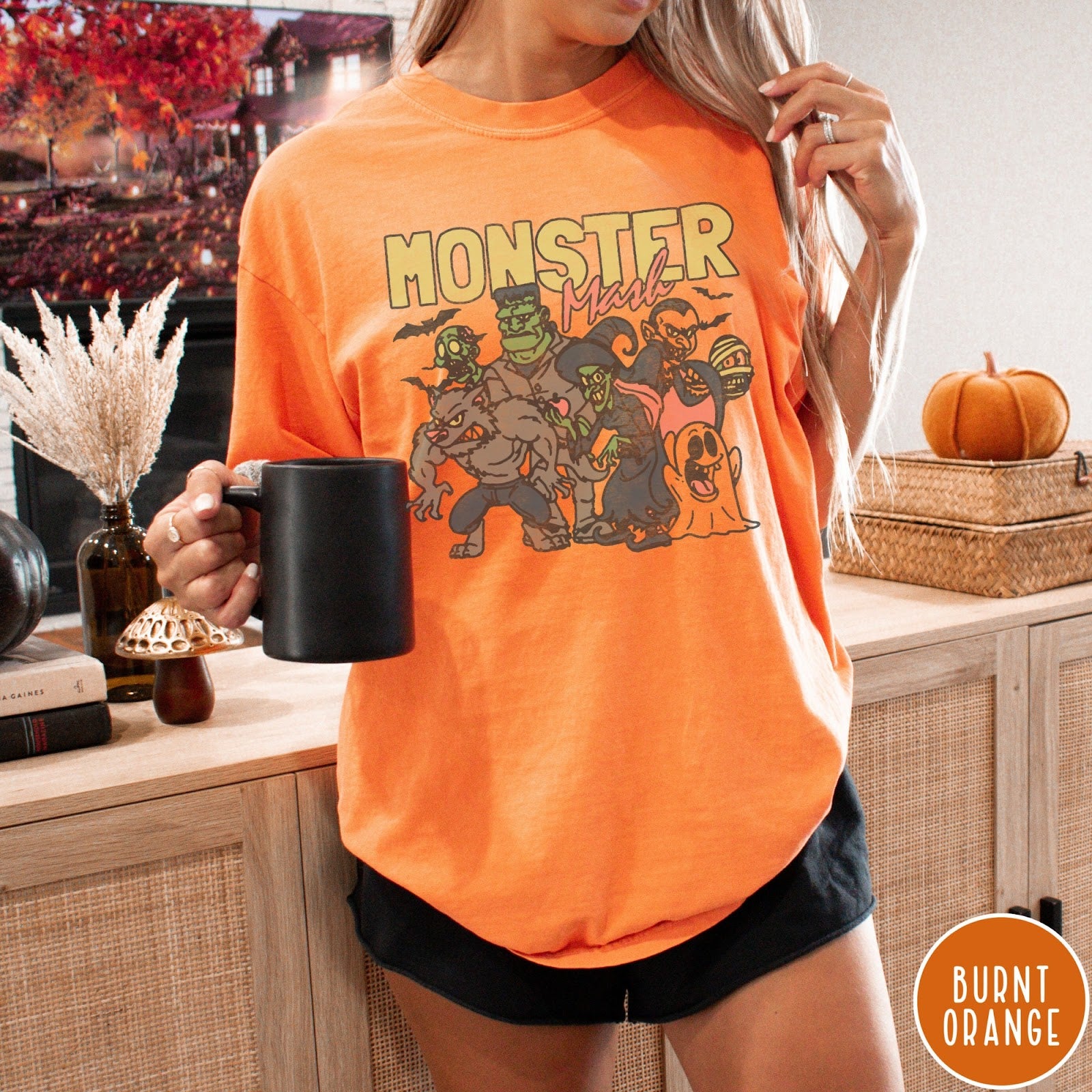 Comfort Colors tee in Burnt Orange featuring retro Halloween style graphic with various classic monsters and spooky characters