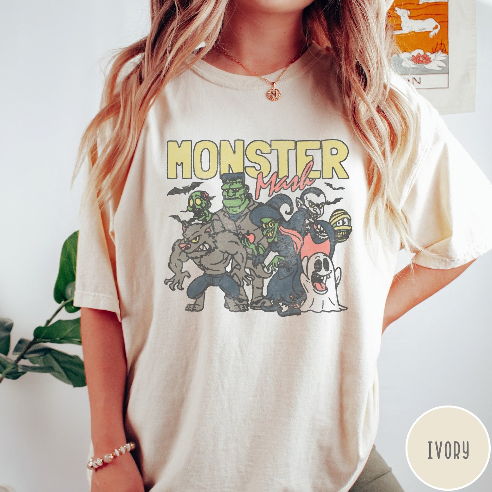 Comfort Colors tee in Ivory featuring retro Halloween style graphic with various classic monsters and spooky characters