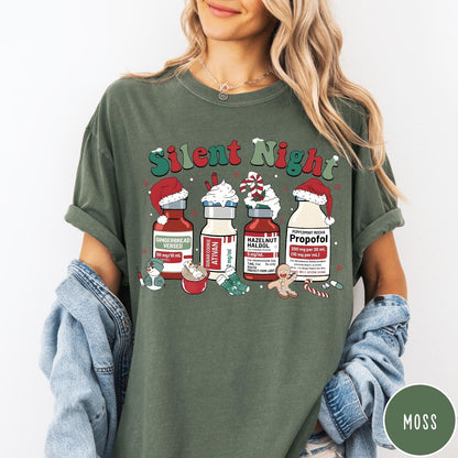 Comfort Colors tee in Moss featuring holiday medical design with vials decorated as festive holiday treats