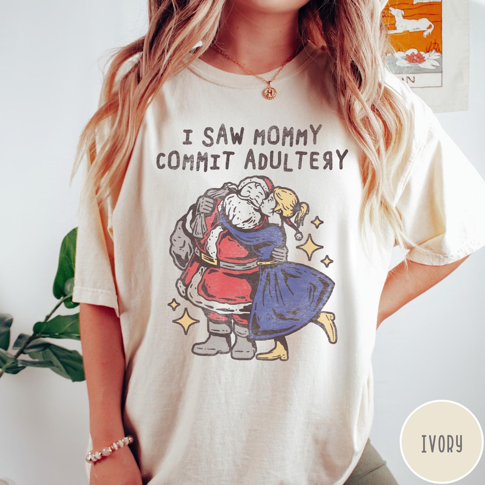 Comfort Colors tee in Ivory featuring vintage style graphic of Santa Claus kissing a woman under stars