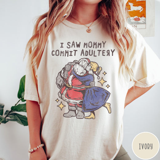 Comfort Colors tee in Ivory featuring vintage style graphic of Santa Claus kissing a woman under stars