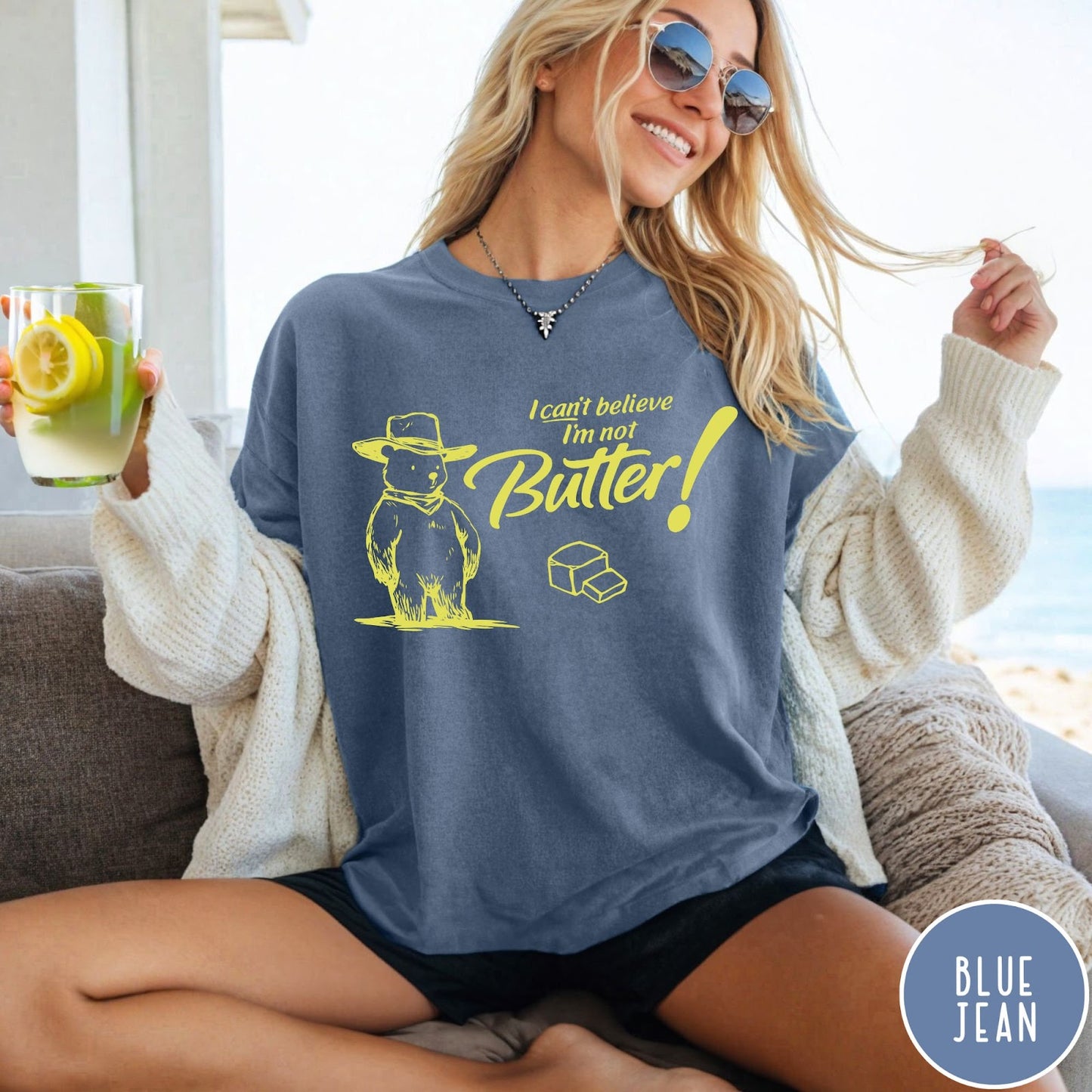 Comfort Colors tee in Blue Jean featuring bear graphic with cowboy hat and text I can't believe I'm not Butter
