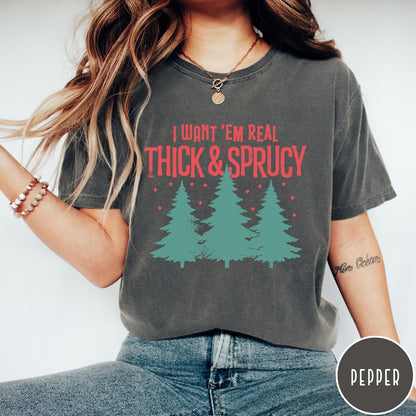 Comfort Colors tee in Pepper featuring Christmas tree design with text I Want Em Real Thick and Sprucy