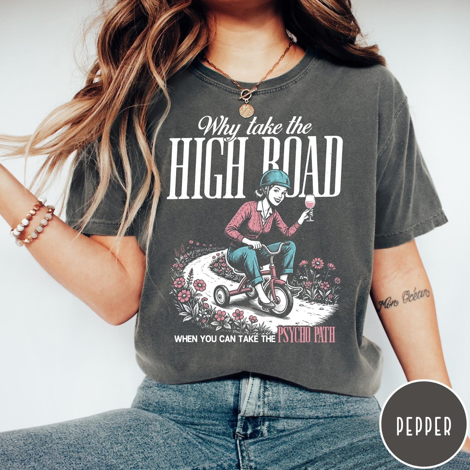 Comfort Colors tee in Pepper featuring vintage style graphic of a woman on a tricycle with wine
