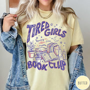Comfort Colors tee in Butter featuring book club design with stacks of books, plants, and candles.
