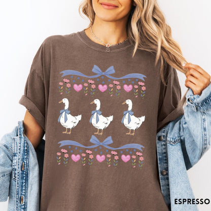 Comfort Colors tee in Espresso featuring vintage style graphic with three geese wearing blue bows and hearts