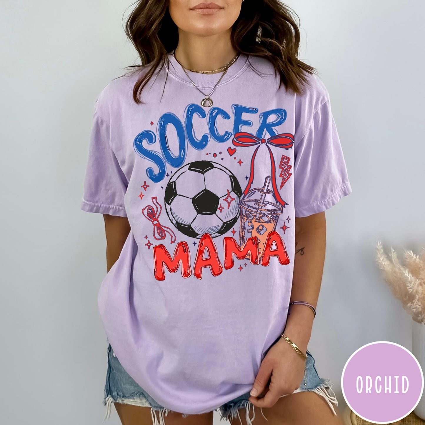 Comfort Colors tee in Orchid featuring soccer graphic with a soccer ball, iced coffee, and red bow