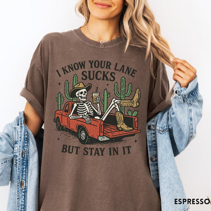 Comfort Colors tee in Espresso featuring western skeleton graphic with cowboy hat and boots in pickup truck