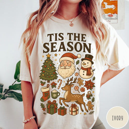 Comfort Colors tee in Ivory featuring Christmas collage graphic with Santa, snowman, reindeer, and holiday gifts