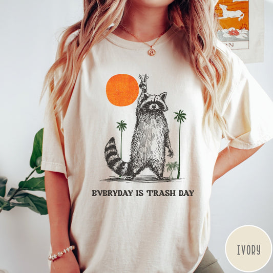 Comfort Colors tee in Ivory featuring vintage style graphic of a raccoon making a peace sign