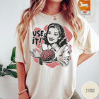 Comfort Colors tee in Ivory featuring retro style graphic of a woman holding a human brain
