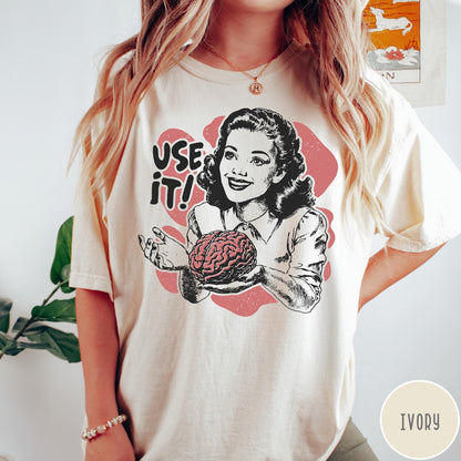 Comfort Colors tee in Ivory featuring retro style graphic of a woman holding a human brain