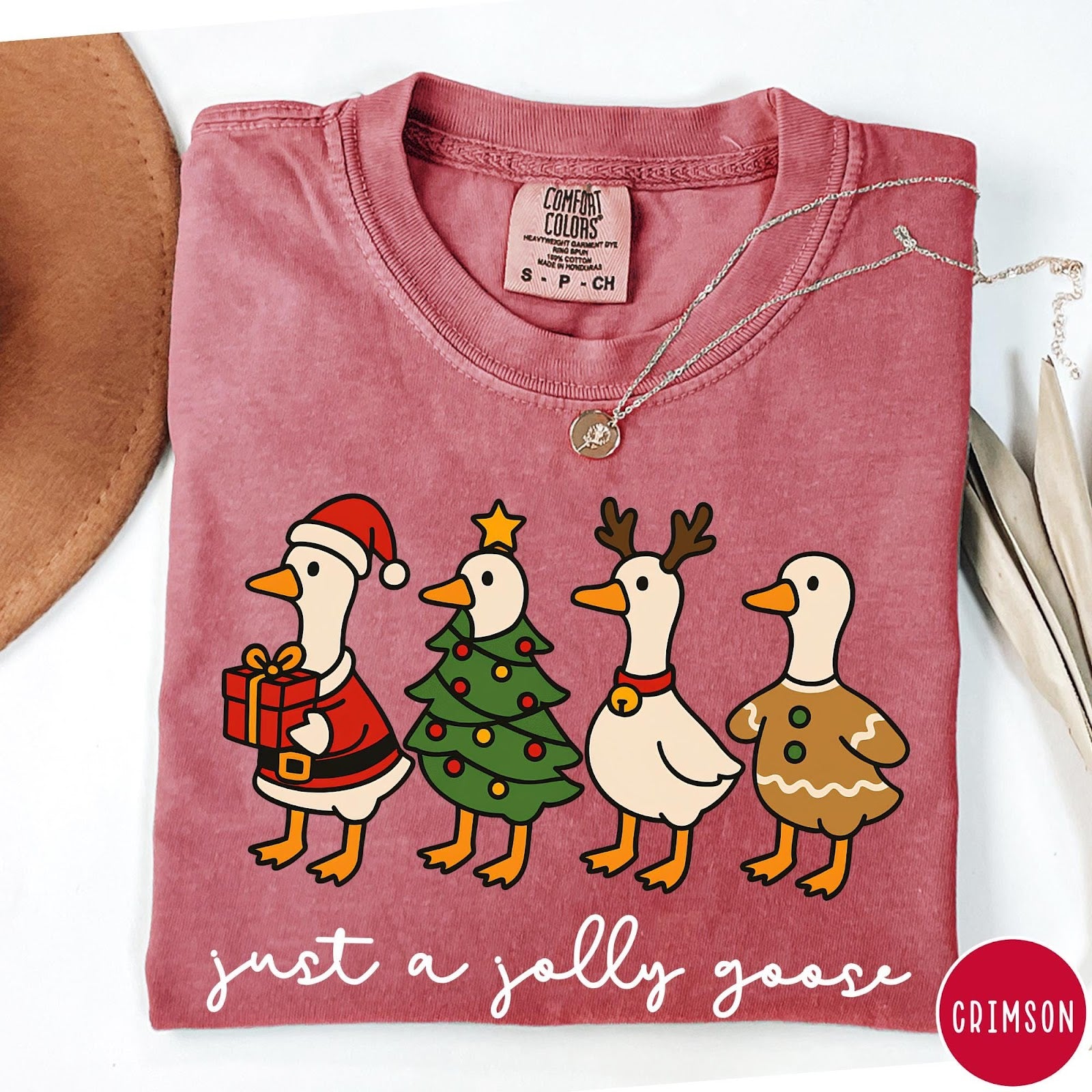Comfort Colors tee in Crimson featuring festive geese graphic with Santa, Christmas tree, reindeer, and gingerbread goose designs