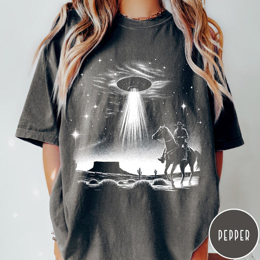 Comfort Colors tee in Pepper featuring western graphic style with a cowboy riding a horse under a UFO