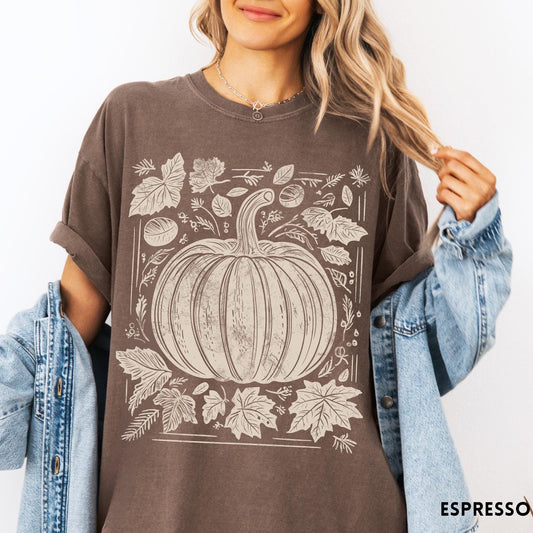 Comfort Colors tee in Espresso featuring rustic pumpkin design with surrounding fall leaves and woodland elements