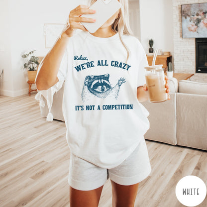 Comfort Colors tee in White featuring screen print style graphic of a raccoon with text Relax We Are All Crazy