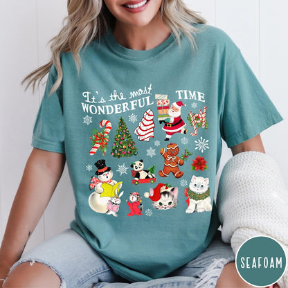 Comfort Colors tee in Seafoam featuring Christmas collage graphic with Santa, snowman, animals, and holiday icons