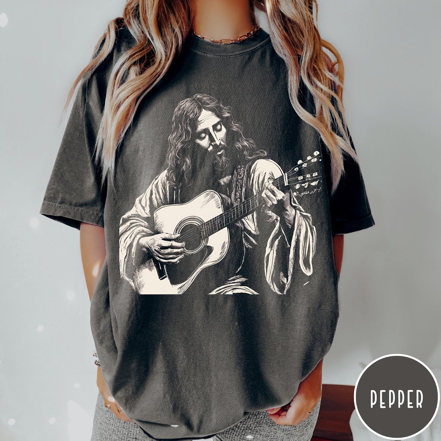Comfort Colors tee in Pepper featuring vintage style graphic of Jesus playing an acoustic guitar