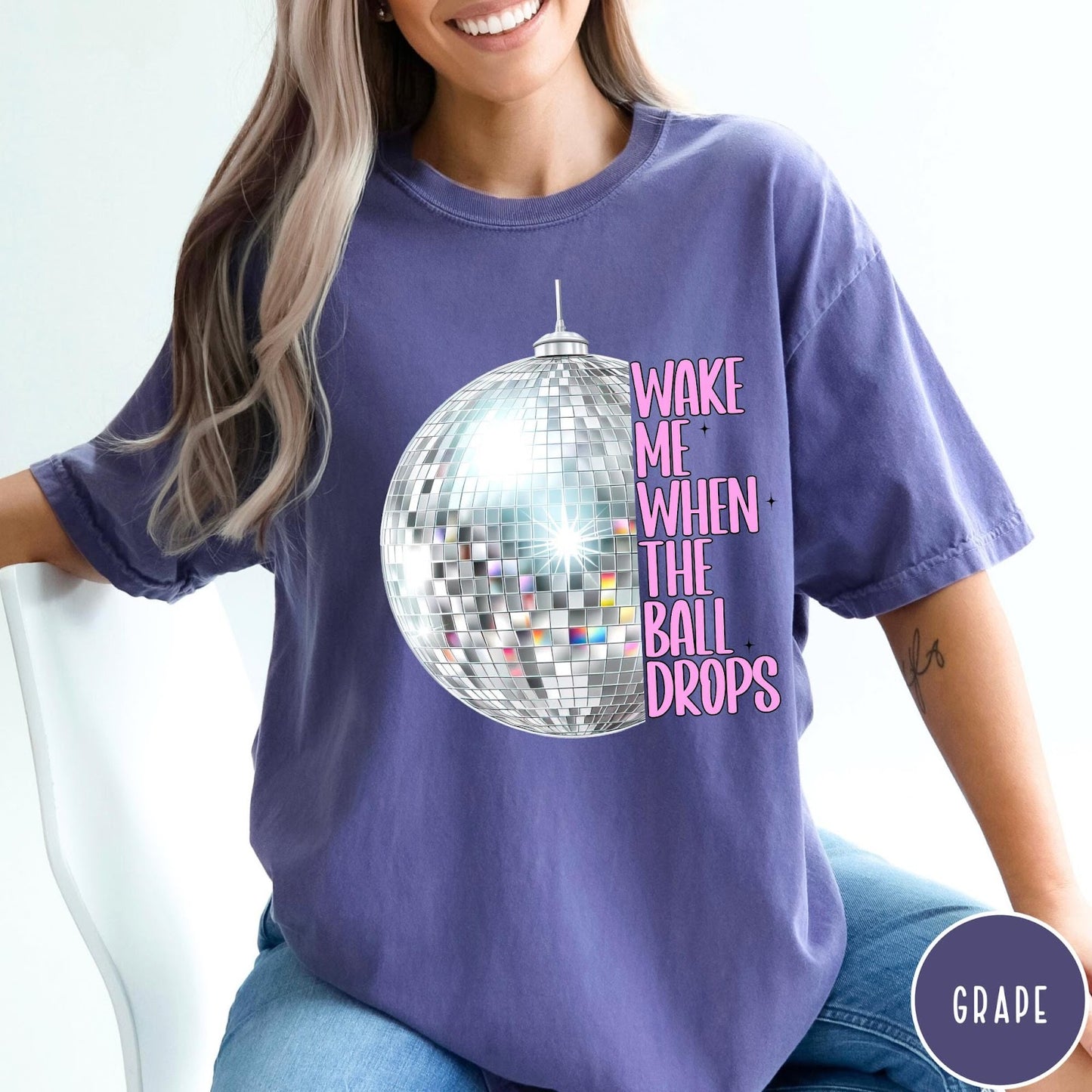 Comfort Colors tee in Grape featuring disco ball graphic with text Wake Me When The Ball Drops