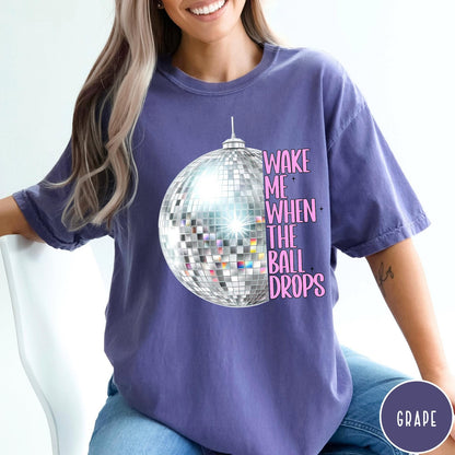 Comfort Colors tee in Grape featuring disco ball graphic with text Wake Me When The Ball Drops