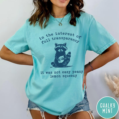 Comfort Colors tee in Chalky Mint featuring screen printed raccoon graphic and text about full transparency and lemons