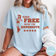 Comfort Colors tee in Chambray featuring cowgirl design with Born Free Now I'm Expensive text and stars