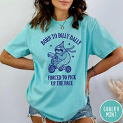 Comfort Colors tee in Chalky Mint featuring cute sloth on a tricycle graphic with Born to Dilly Dally text